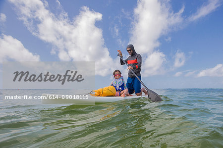 Father and daughter paddle boarding in the Gulf of Mexico, Destin, Florida, USA