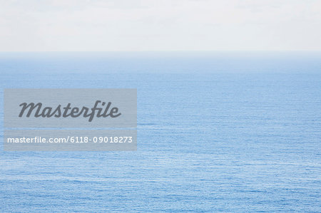 View from the land over the ocean, to the horizon. Open space, seascape and skyscape.