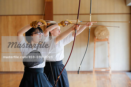 Multi-ethnic traditional Kyudo Japanese archery athletes practicing