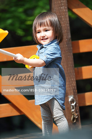 Mixed-race young girl playing on wooden deck