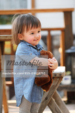 Mixed-race young girl with teddy bear