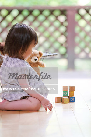 Mixed-race young girl with wooden blocks