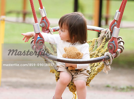 Mixed-race young girl playing at the park