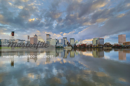 Storm Clouds over Portland Oregon city skyline along Willamette River waterfront during sunset