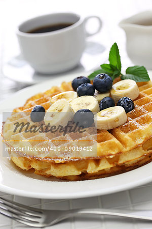 homemade american round waffles with blueberry and banana