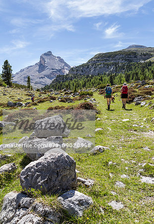 Italy,South Tyrol,Bolzano district,San Vigilio di Marebbe, Hikers in Fanes valley with Mount Piz Taibun in the background