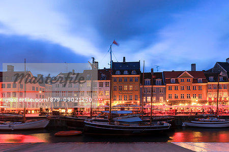 Night view of the illuminated harbour and canal of the entertainment district of Nyhavn, Copenhagen, Denmark, Europe