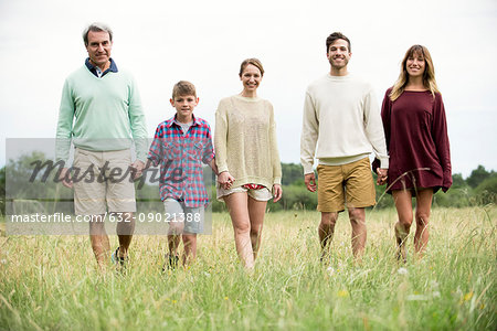 Family walking together through meadow