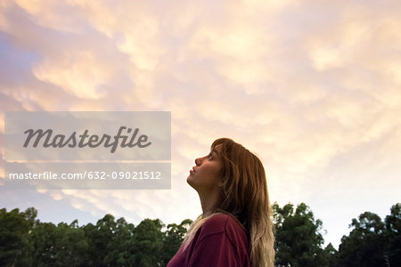 Young woman gazing at evening sky