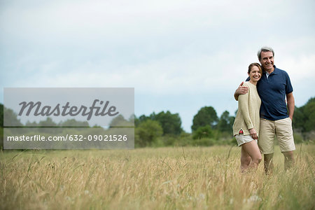 Couple standing together in tall grass