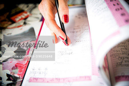 Woman writing in appointments book