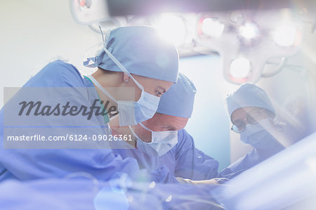 Focused surgeons performing surgery in operating room