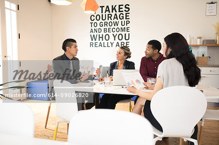 Young businessman explaining at team meeting