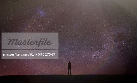 Silhouette of man looking away at starry night sky, Death Valley, California, United States, North America