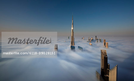 View of the Burj Khalifa and other skyscrapers above the clouds in Dubai, United Arab Emirates.