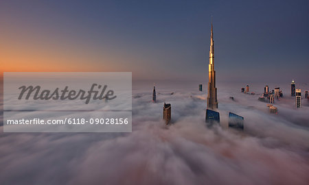 View of the Burj Khalifa and other skyscrapers above the clouds in Dubai, United Arab Emirates.