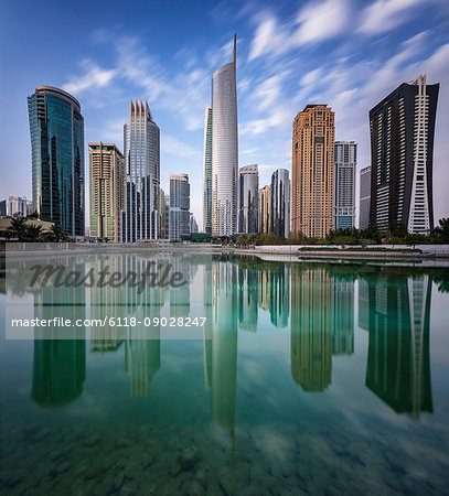 Cityscape of Dubai, United Arab Emirates, with skyscrapers lining the waterfront.