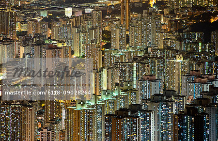 Aerial view of illuminated skyscrapers in Hong Kong at night.
