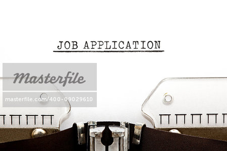 Headline Job Application typed on old typewriter.