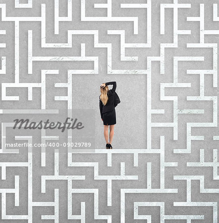 Confused businesswoman at the center of a big maze