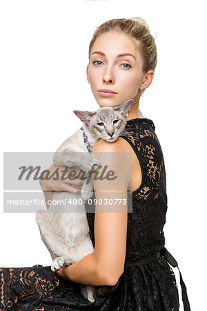 Beautiful blond girl with oriental siam cat isolated on white background. Copy space.