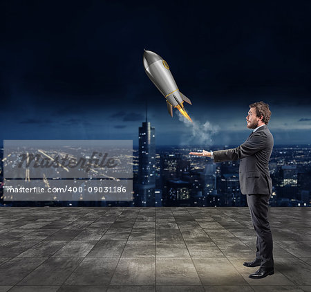 Businessman throws a rocket in the sky. Startup of a new company concept