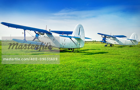 biplanes on a meadow are waiting for the next flight