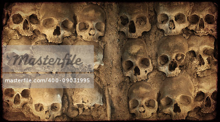 Grunge Halloween background with human skulls and paper texture of brown color