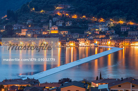 The Floating Piers and Peschiera Maraglio at dusk in Iseo Lake - Italy, Europe