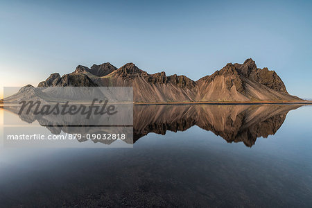 Stokksnes, Hofn, Eastern Iceland, Iceland. Vestrahorn mountain mirrors in the waters of the Stokksnes bay.