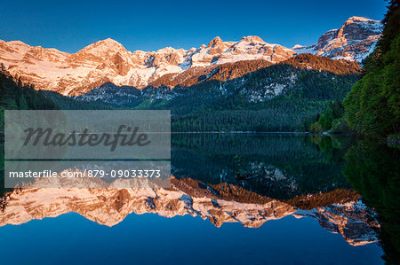 Tuenno, Tovel lake, Trento province, Trentino Alto Adige, Italy. The Brenta dolomites's range is reflected into the Tovel lake, in Tuenno country