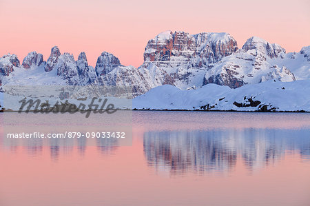 Nero lake, Adamello Brenta natural park, Trentino Alto Adige, Italy. The Brenta Dolomites in winter are reflected in the waters of Black Lake at sunset.