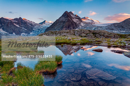 Carisolo, Genova valley, Adamello-Brenta natural park, Trento province, Trentino Alto Adige, Italy. The Three Lobbie and Adamello glacier are reflected at sunset into a small lake near Mandrone refuge