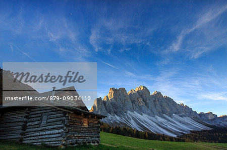 The early morning light illuminates Malga Zannes and the Odle in background. Funes Valley South Tyrol Dolomites Italy Europe