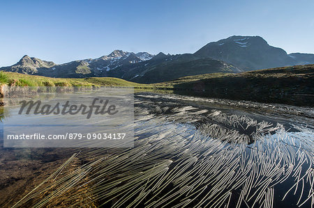 Peaks Suretta and Spadolazzo are reflected in Lake Andossi at sunrise Chiavenna Valley Valtellina Lombardy Italy Europe