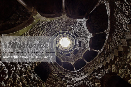 Spiral stairs and mystical atmosphere inside the towers of Initiation Well at Quinta da Regaleira Sintra Portugal Europe