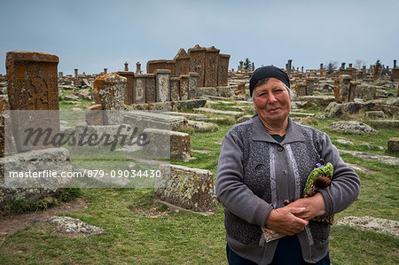 Armenian woman in the historical cemetery of Noratus near Lake Sevan, Armenia, Caucaus, Eurasia.
