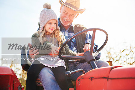 Farmer and granddaughter at pumpkin farm
