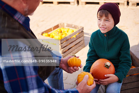 Farmer and grandson at pumpkin farm