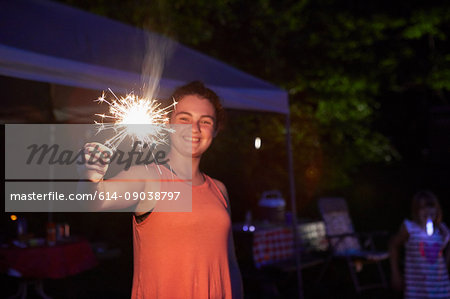 Girl outside at night, using sparkler