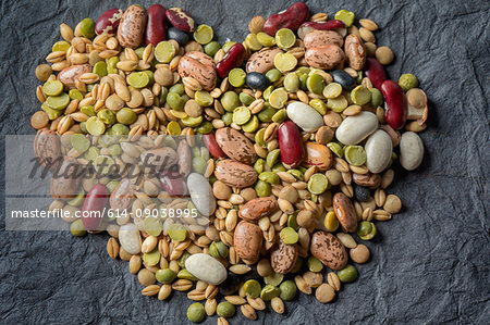 Overhead view of dried lentils, beans and barley in heart shape