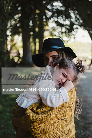 Mother comforting upset crying girl