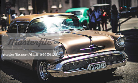 A classic 1950s car in a busy street.