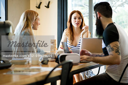 Colleagues talking together in casual office