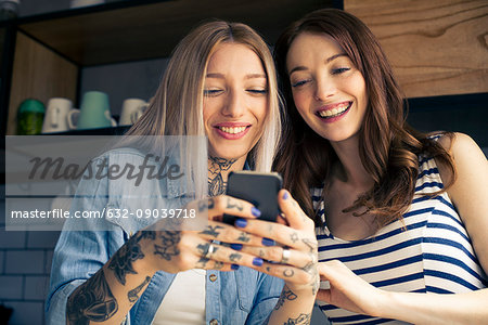 Women looking at smartphone together