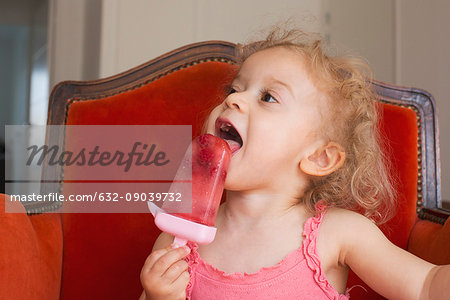 Little girl eating popsicle