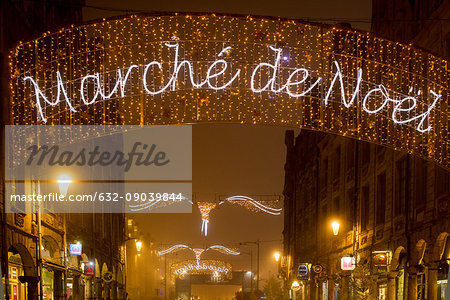 Illuminated sign advertising an outdoor Christmas market in Arras, France