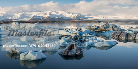 Floating icebergs and Vatnajokull Glacier on the background. Jokulsarlon Glacier Lagoon, Eastern Iceland, Europe