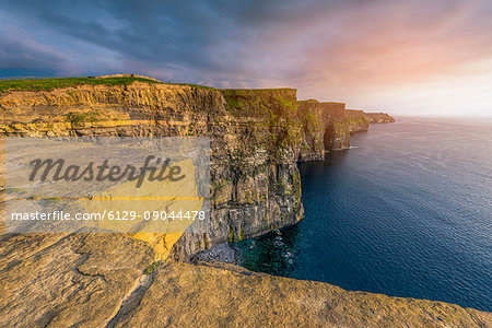 Cliffs of Moher (Aillte an Mhothair), Doolin, County Clare, Munster province, Ireland, Europe. Sunset over the cliffs. Cliffs of Moher (Aillte an Mhothair), Doolin, County Clare, Munster province, Ireland, Europe. Sunset over the cliffs.
