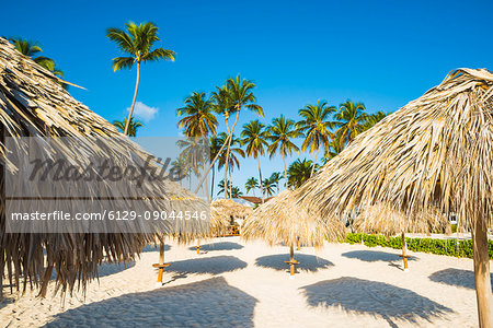 Bavaro Beach, Bavaro, Higuey, Punta Cana, Dominican Republic. Thatch beach umbrellas.